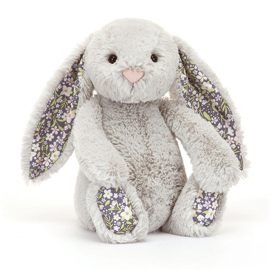 Plush bunny toy with floral ears and feet on a silver background