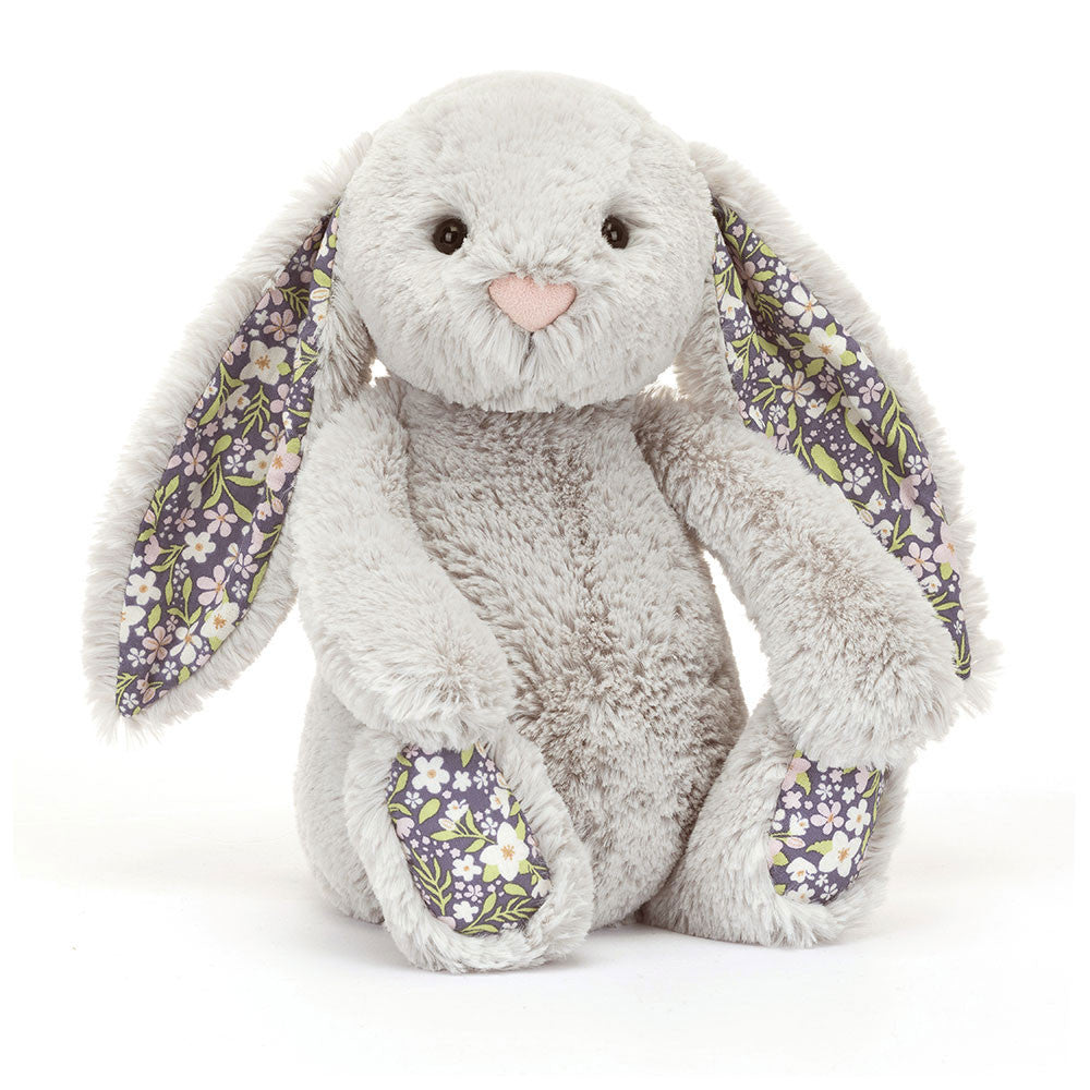 Plush bunny toy with floral ears and feet on a silver background