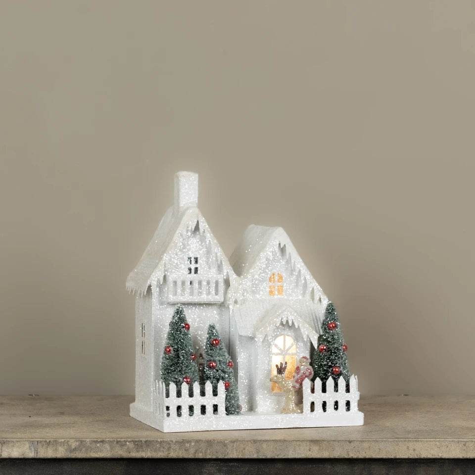 Lighted Snow Covered House with Balcony
